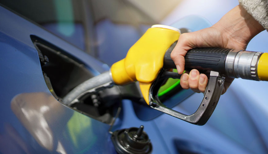Person fueling a car at a filling station