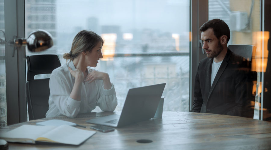 manager in meeting with an employee both look upset