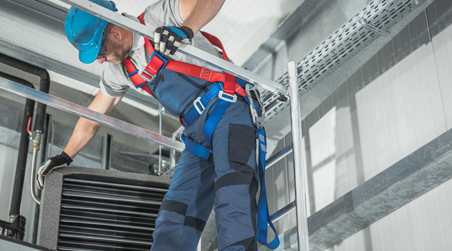 construction worker installing heating system equipment